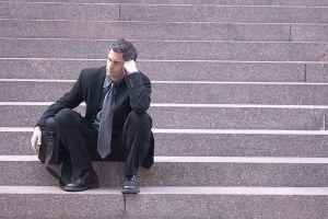 Disappointed Man sitting on step